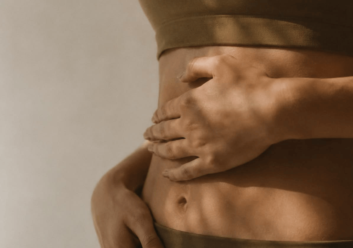 womans stomach on light background