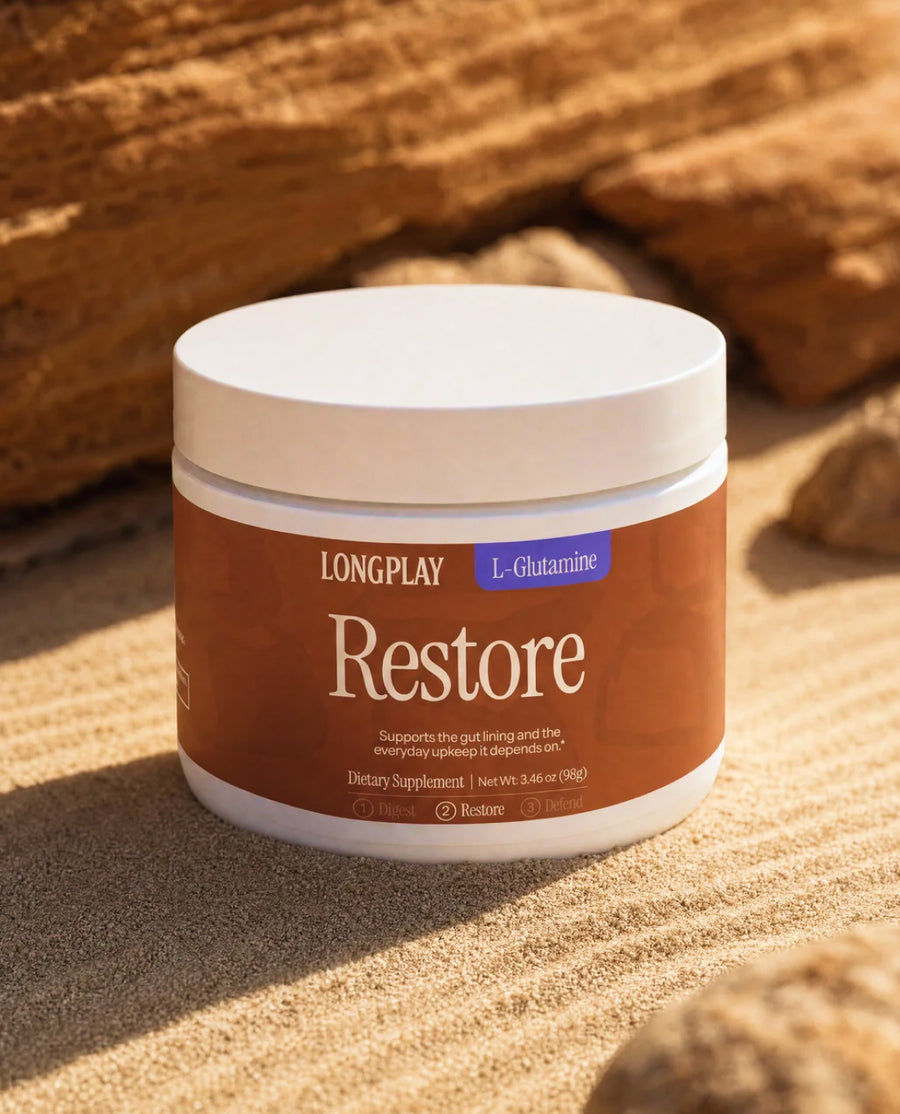 Longplay Restore L-Glutamine tub on rippled sand and layered stone