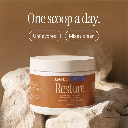 A jar of Longplay Restore dietary supplement placed on white rocks against a warm brown background, with text above reading 'One scoop a day.' and 'Unflavored' and 'Mixes clean'.